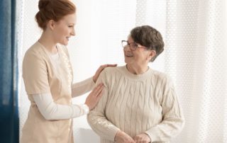 A senior woman receives home care assistance.