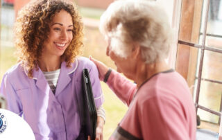 A happy caregiver enters the home of a client, representing in-home recovery care.