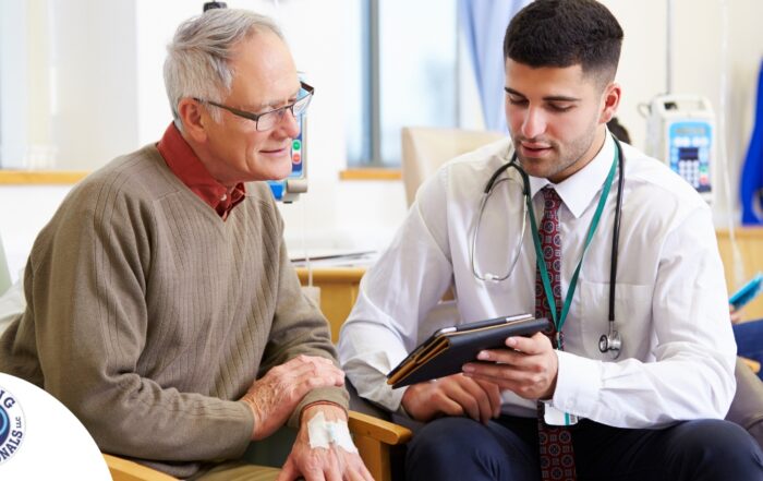 An older man talks with a doctor representing the effective communication that family caregivers should endeavor to have.