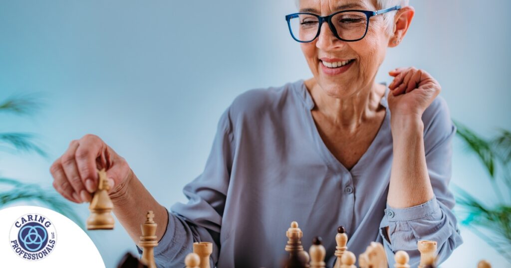 An older woman plays chess, an activity that can help older adults stay sharp.