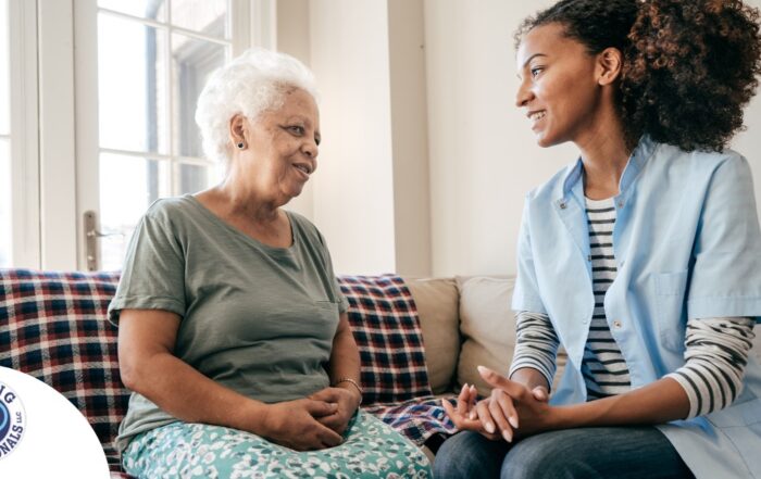 A caregiver sits and spends time with a client, representing how non-medical home care can benefit older loved ones.