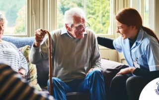 A woman has a good time with her older clients, representing the kind of personal skills needed to be a good caregiver.