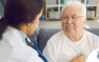 A doctor examines an older man with a stethoscope, representing pneumonia in elderly adults.