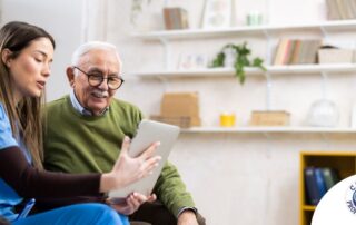 Home caregiver assisting senior man to use telehealth and senior care